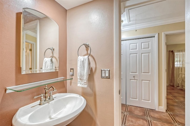 bathroom featuring sink, tile patterned flooring, and ornamental molding