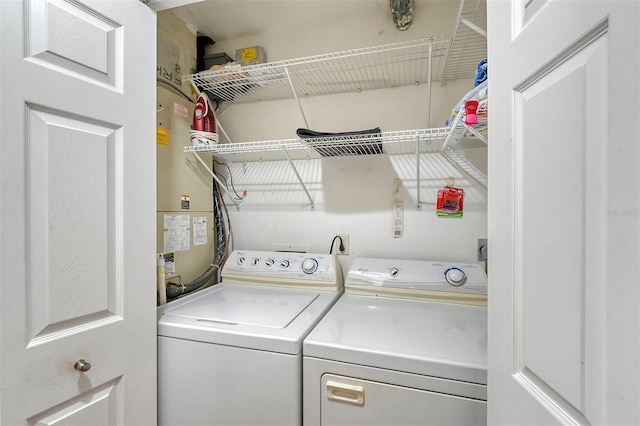 laundry area with gas water heater and independent washer and dryer