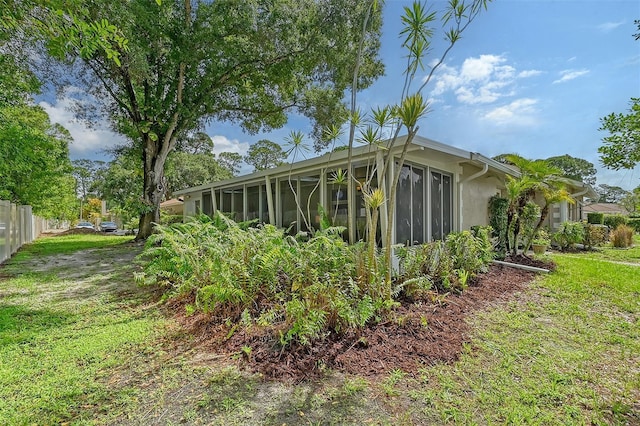 view of home's exterior with a sunroom