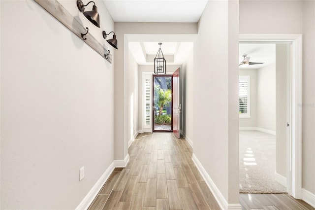 doorway to outside featuring a wealth of natural light and ceiling fan