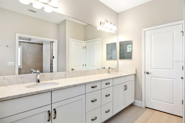 bathroom featuring tile patterned floors and vanity