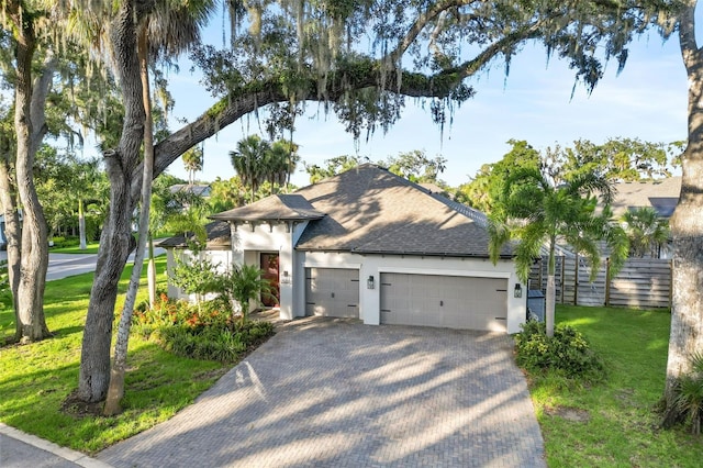 view of front of home with a garage and a front lawn