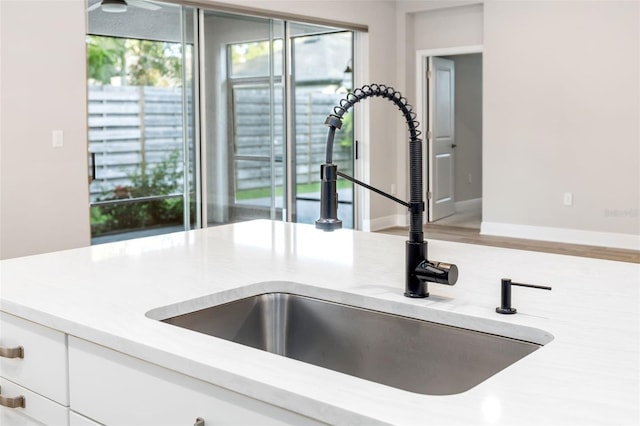 details featuring white cabinetry and sink