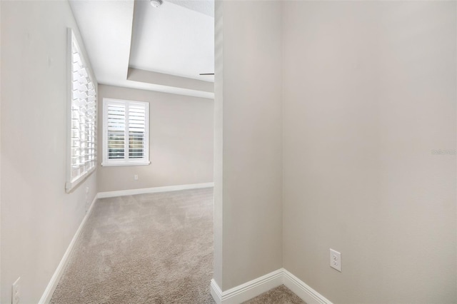 unfurnished room featuring light colored carpet