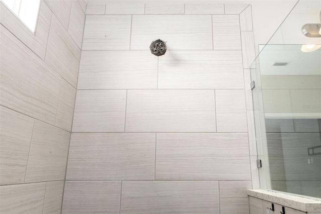 bathroom with tiled shower