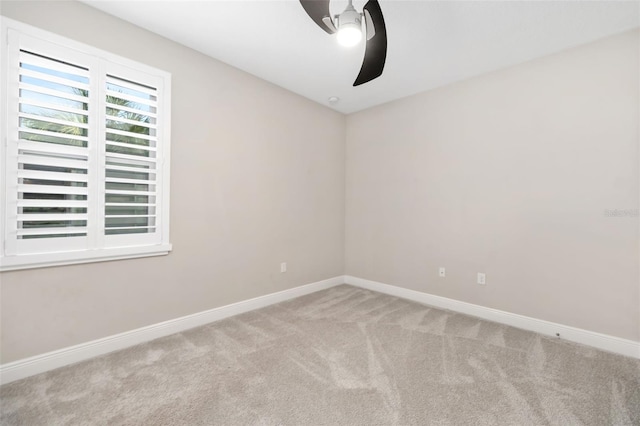 empty room with ceiling fan and light carpet