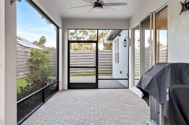 sunroom featuring ceiling fan