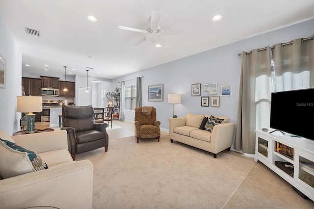 living room featuring ceiling fan and light tile patterned flooring