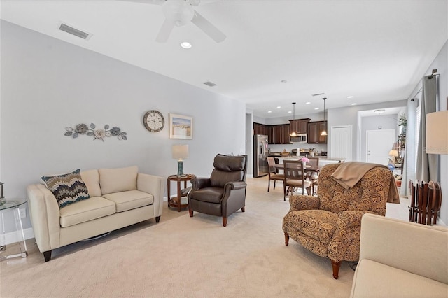 carpeted living room featuring ceiling fan