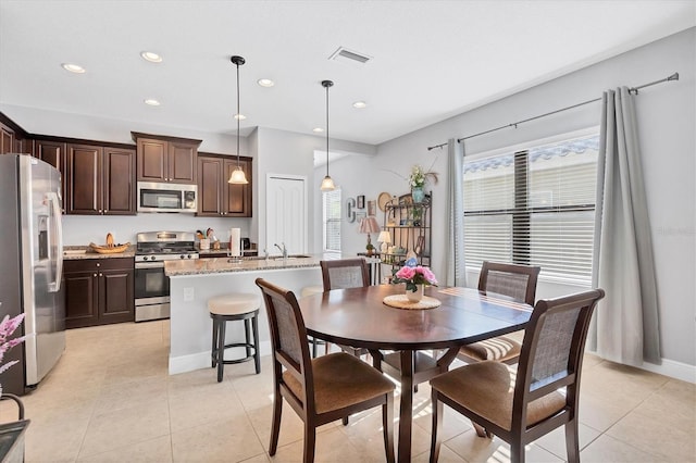 tiled dining area featuring sink