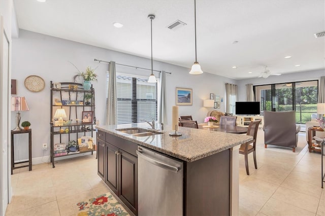 kitchen featuring dishwasher, sink, ceiling fan, light stone countertops, and decorative light fixtures