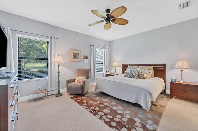 bedroom featuring ceiling fan and light carpet