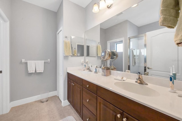 bathroom with tile patterned flooring, vanity, and an enclosed shower