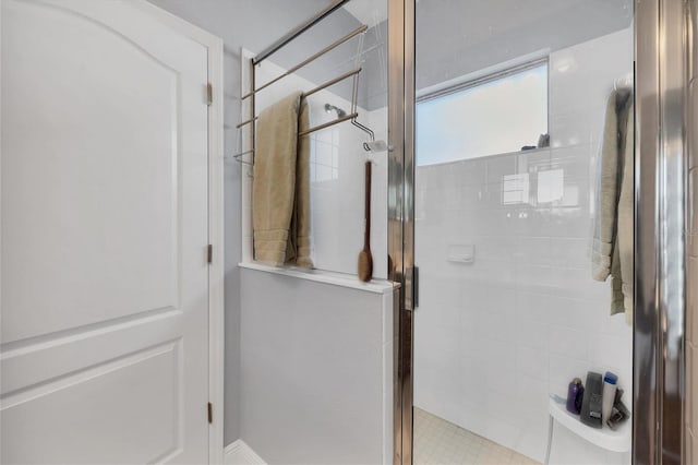 bathroom with a shower with door