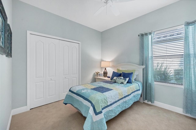 carpeted bedroom featuring a closet and ceiling fan