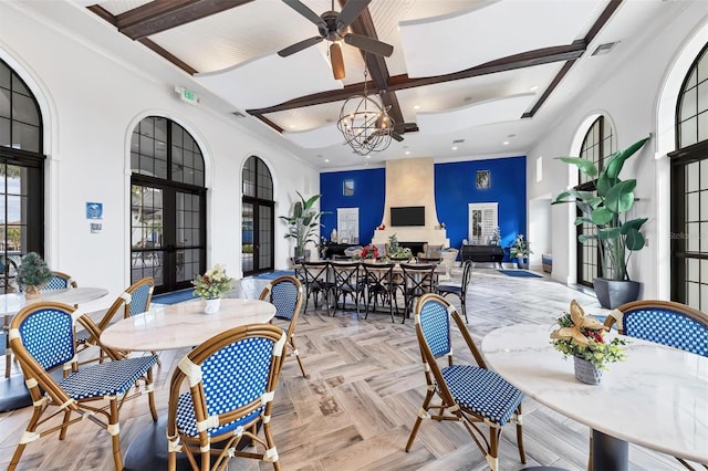 dining room featuring french doors, coffered ceiling, ceiling fan with notable chandelier, beamed ceiling, and light parquet flooring