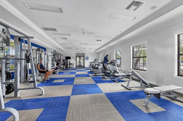 exercise room featuring a textured ceiling, ceiling fan, and crown molding