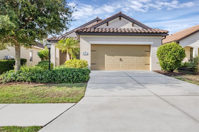 mediterranean / spanish-style home with a garage