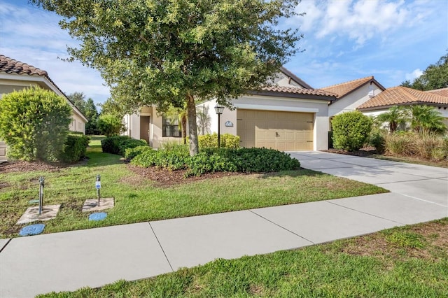 mediterranean / spanish-style house featuring a front lawn and a garage