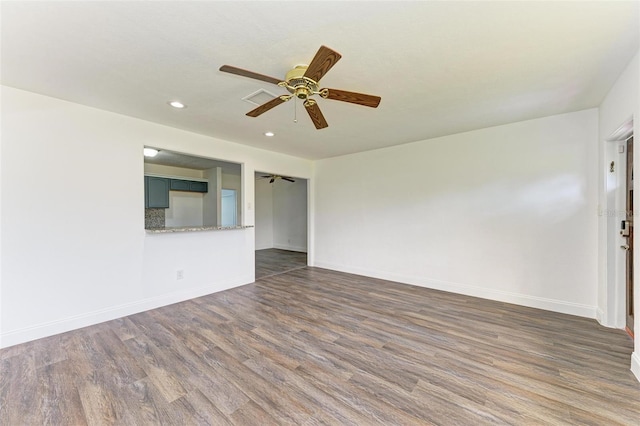 unfurnished room with dark hardwood / wood-style floors and ceiling fan