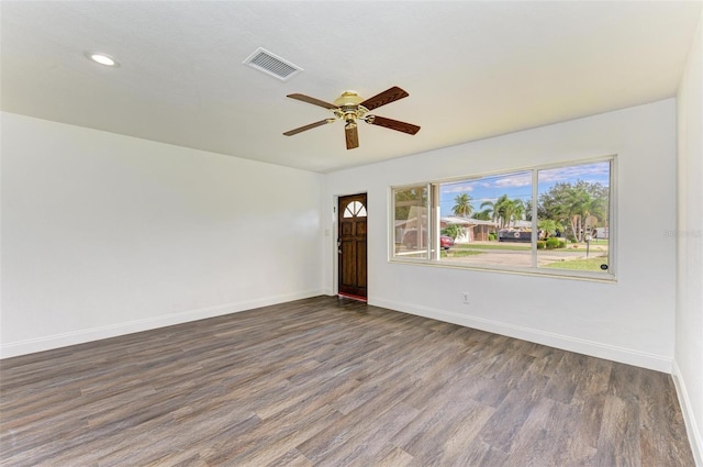 empty room with dark hardwood / wood-style floors and ceiling fan