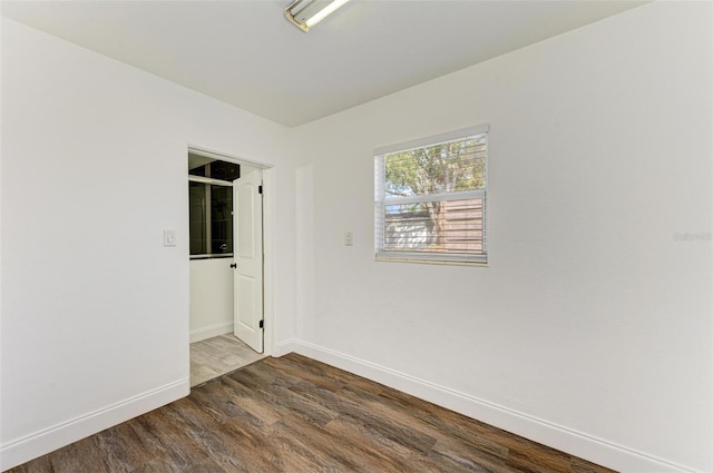 spare room featuring dark wood-type flooring