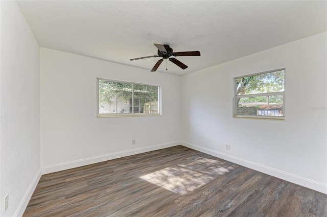 unfurnished room with dark hardwood / wood-style floors and ceiling fan