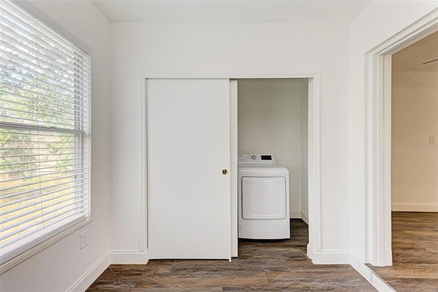 clothes washing area with a healthy amount of sunlight, dark wood-type flooring, and washer / clothes dryer