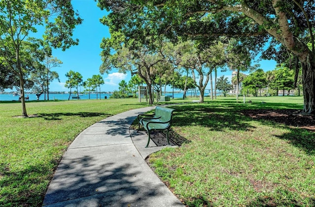 view of property's community with a water view and a yard