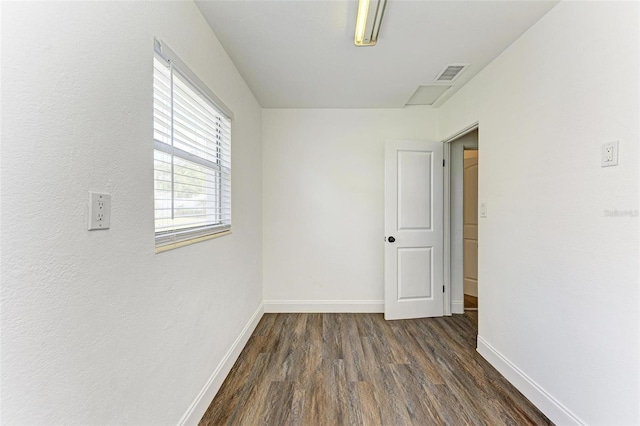 empty room featuring dark hardwood / wood-style flooring