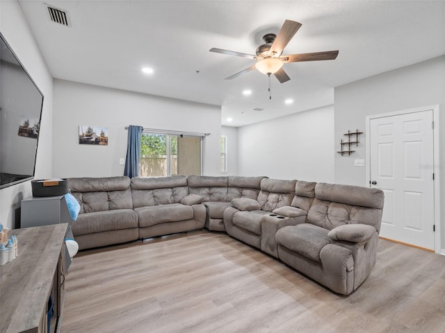 living room with light wood-type flooring and ceiling fan