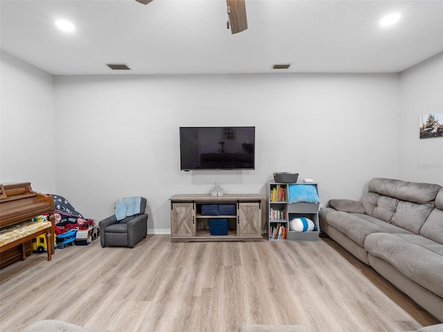 living room with ceiling fan and light hardwood / wood-style floors