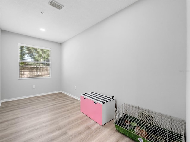 empty room with light hardwood / wood-style flooring