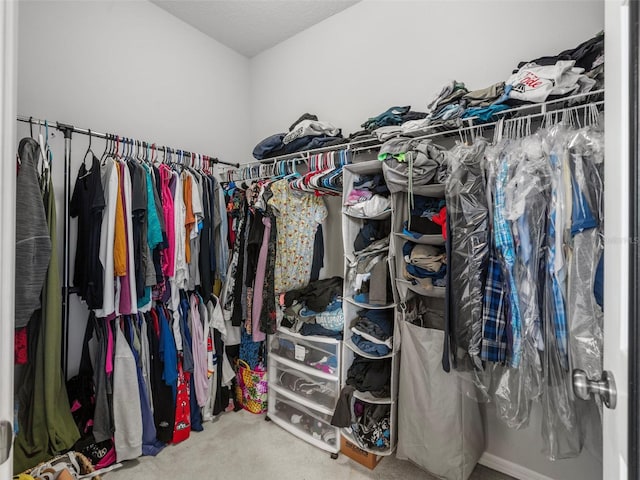 spacious closet with carpet flooring