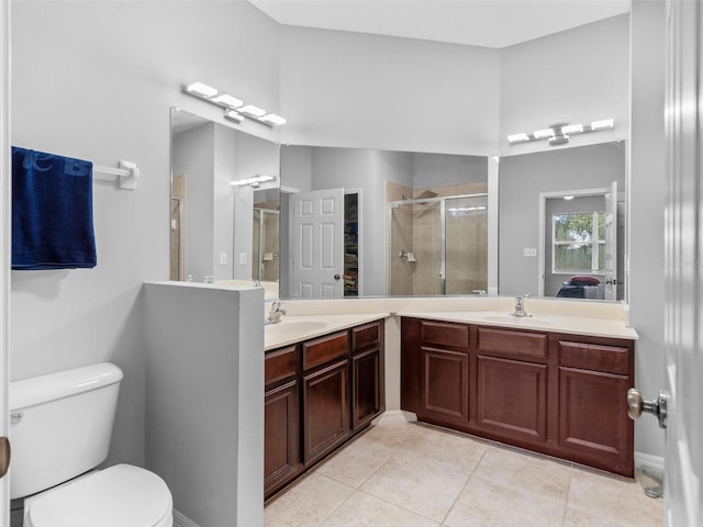 bathroom featuring a shower with shower door, tile patterned floors, vanity, and toilet