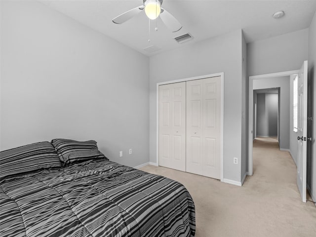 bedroom with ceiling fan, a closet, and light carpet