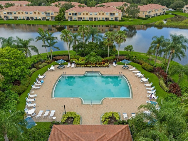 view of pool with a patio area and a water view