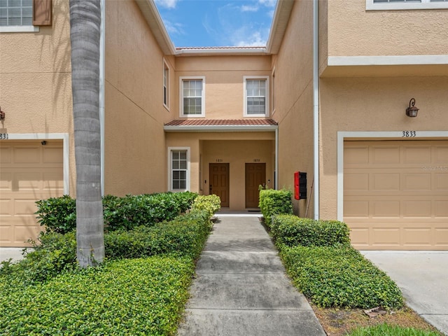 doorway to property with a garage