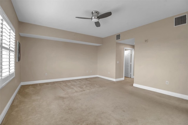 spare room featuring ceiling fan and light colored carpet