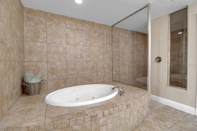 bathroom featuring tiled bath, tile patterned floors, and tile walls