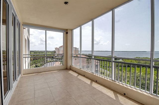 unfurnished sunroom with a water view