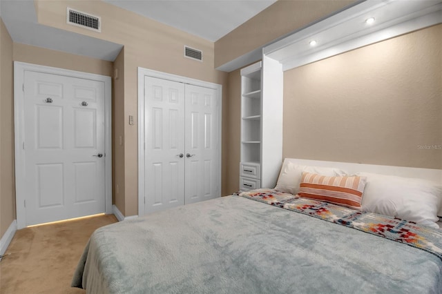 bedroom featuring light colored carpet and a closet