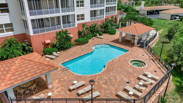 view of pool featuring a hot tub and a patio area