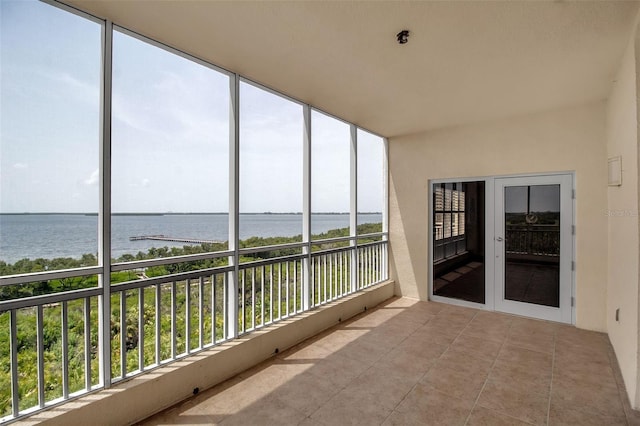 unfurnished sunroom with a water view