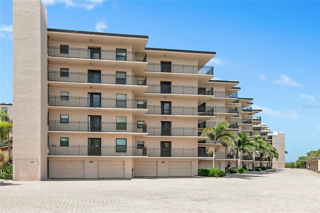 view of building exterior with an attached garage and driveway