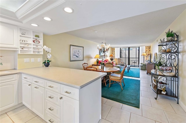 kitchen with light tile patterned flooring, recessed lighting, a peninsula, white cabinetry, and light countertops