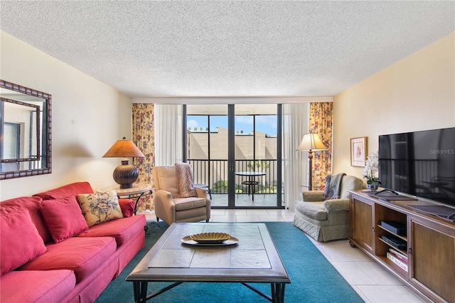 living room with a wall of windows, light tile patterned flooring, and a textured ceiling