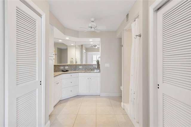 bathroom with double vanity, visible vents, a ceiling fan, tile patterned floors, and a closet