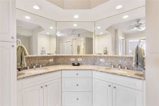 bathroom featuring a ceiling fan, recessed lighting, and a sink