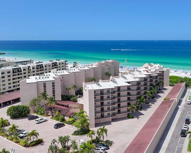 drone / aerial view featuring a water view and a view of the beach